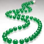 The Hutton-Mdivani Necklace, comprised of 27 enormous Qing jadeite beads with an Art Deco ruby and diamond clasp by Cartier