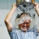 SoftBank Corp. Chief Executive Masayoshi Son dumps a bucket of ice water onto himself as he takes part in the ALS ice bucket challenge at the company headquarters in Tokyo