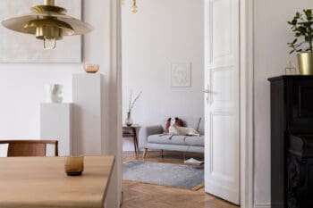 Stylish scandi interior of home space with design wooden table,